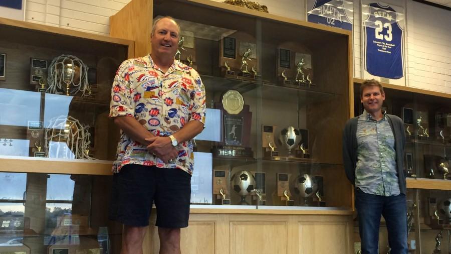 Two of the most prolific coaches in Broomfield history, Mike Croell and Jim Davidson, stand for a photo by the trophy cases at the entrance to the Eagle Gym.