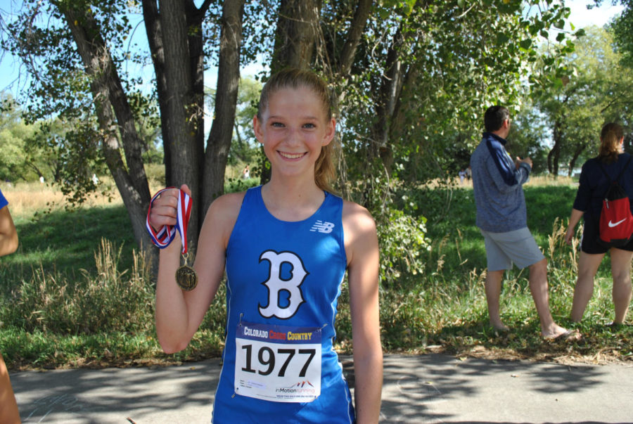 Sydney holding her gold medal, minutes after crossing the finish line.