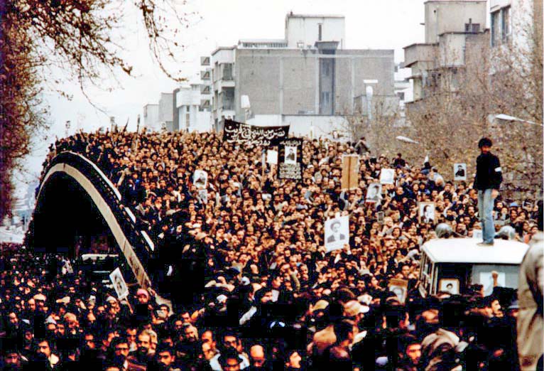 In 1979, protestors march across the College Bridge in Tehran. Signs with famous Shi’ite clergyman Ruhollah Khomeini are visible.