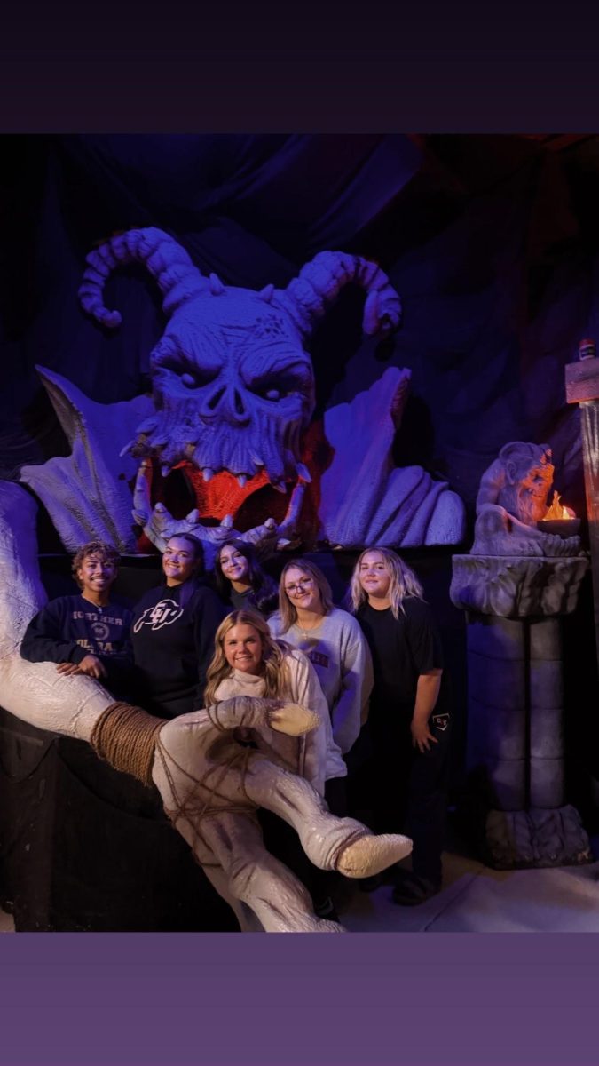 A group of friends stop for a picture at the end of going through the Frightmare haunted house.